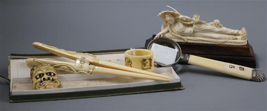 An Oriental carved ivory figure on wooden stand, a pair of boxed ivory glove stretchers, napkin ring, etc. (5)